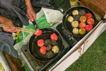 Man prepares dumplings at thai street food outdoor market. Close up.