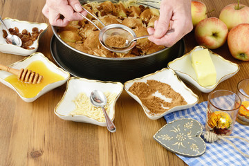 baking apple pie with ingredients around like honey almond and cinnamon