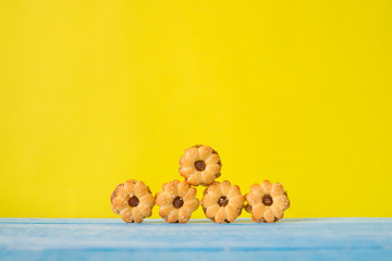 Biscuit with pineapple jam on the blue sky wooden table and yellow background.