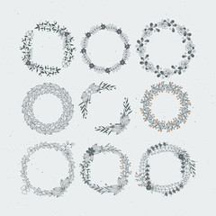 Fototapeta premium Round frames from branches and leaves. Rustic wedding ornaments. Vintage hand drawn illustrations