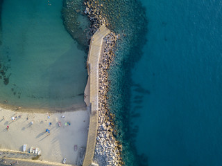 Vista aerea di una spiaggia e di un molo con canoe, barche e ombrelloni. Pizzo Calabro, Calabria, Italia