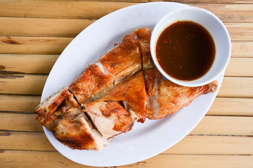 Grilled chicken on a plate with dipping sauce