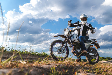 Obraz premium travel motorcycle off road Motorcyclist gear, A motorcycle driver looks, concept, active lifestyle, enduro