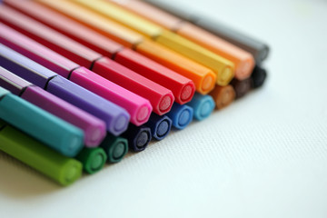 Fototapeta premium Set of coloring pens/markers on white background; close up, selective focus.