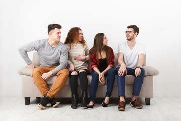 Students wait for exam, sitting on couch indoor