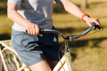 Pleasant woman riding bicycle in the park