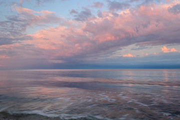 
Quiet and calm coast of the ocean (sea) at sunset (dawn) of the sun. Summer seascape 