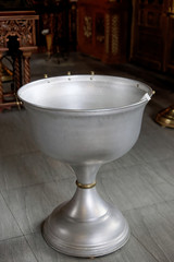 The baptism of a child in the Orthodox Church. Chan for ablution.