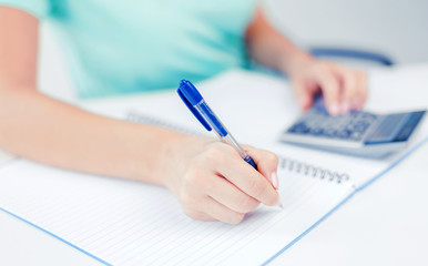 Fototapeta premium businesswoman working with calculator in office