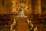 Stylish hipster wedding couple in romantic loft decorations at night