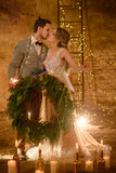 Stylish hipster wedding couple in romantic loft decorations at night