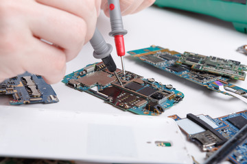 Repairing smartphone with multimeter close up