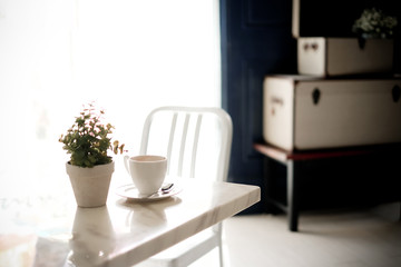 A cup of coffee on table in room,vintage filter,selective focus.