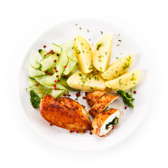 Stuffed chicken fillets and vegetables on white background