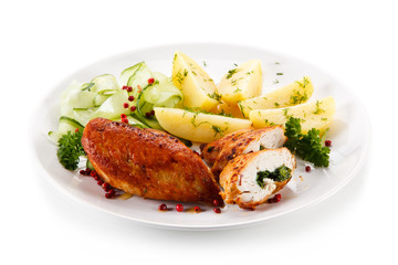 Stuffed chicken fillets and vegetables on white background