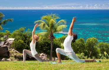 couple making yoga in low lunge pose outdoors
