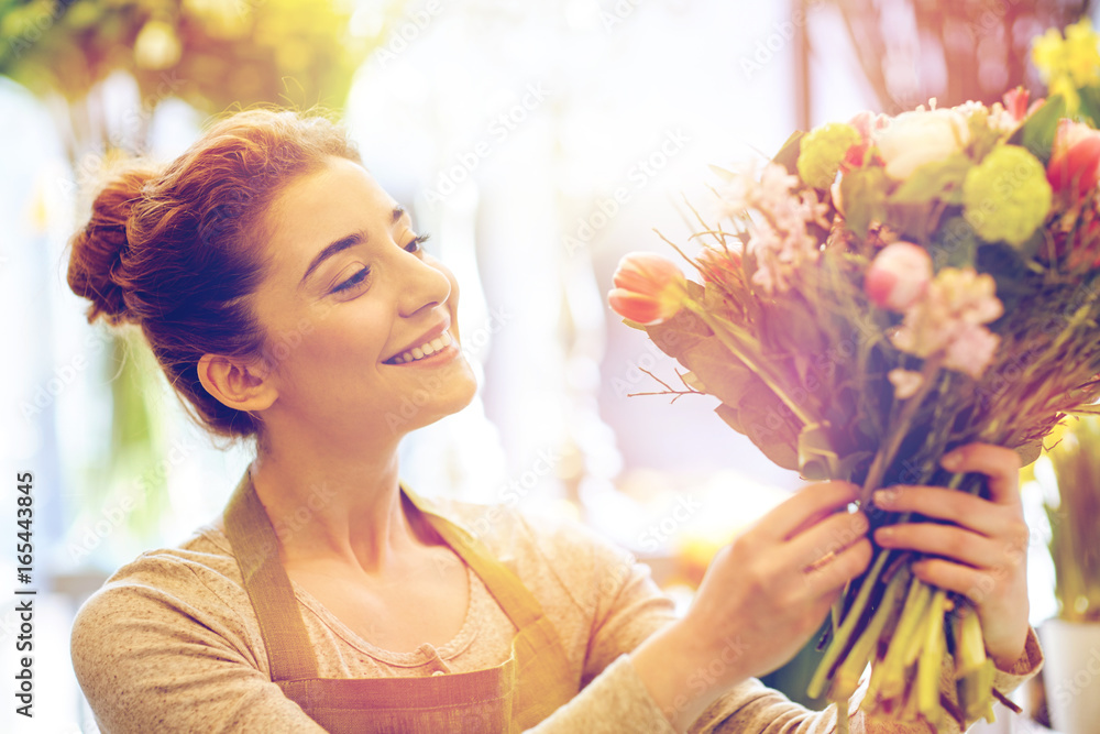 Canvas Prints smiling florist woman making bunch at flower shop