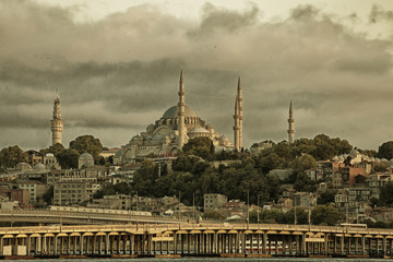 Fototapeta na wymiar Suleymaniye mosque view from Halic at cloudy day, yellow effect applied