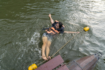 asian female in life jacket sitting near river in kanchanaburi thailand., on the Waterfront