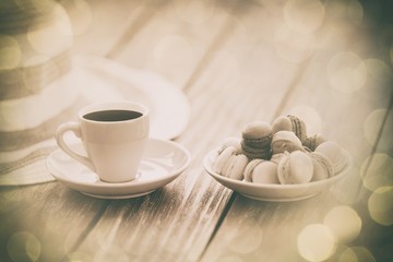 Cup of coffee and macarons with hat
