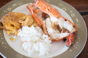 Thai Jasmine rice eating with shrimp and omelet