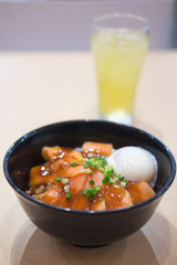 a big bowl of rice with fresh salmon
