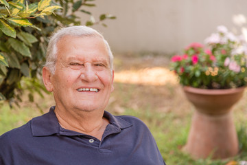 portrait of soft skin old man in home garden