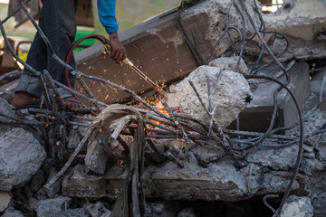 Technician cutting steel with gas and have fire sparkling in site construction.