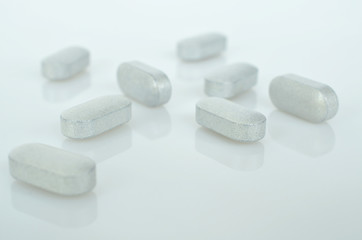 Obraz na płótnie Canvas Pharmacy theme, white medicine tablets antibiotic pills.