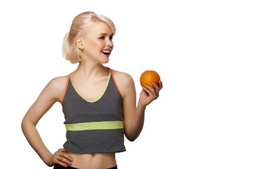 Happy smiling slim woman holding the orange, studio portrait isolated on white background, healthy lifestyle concept