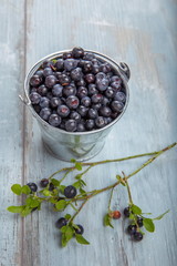 Fresh forest berry, blueberries in a glass plate on a wooden table