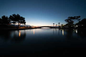 Fototapeta na wymiar Pond in the park at night with blue sky