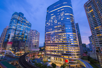 Bangkok business intersection at dusk. Location is Sathorn-Naratiwas road with office buildings and hotels around.