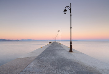 Sunset at a pier in the harbor of Kos town, Greece.