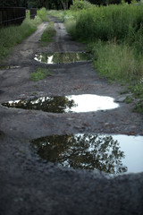 landscape after rain - puddles on the road