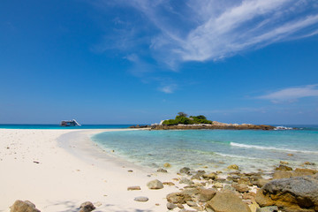 relaxing on the white sand beach at Racha island in Phuket Thailand