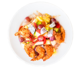 Fried shrimp with mixed fruit salad in white dish.