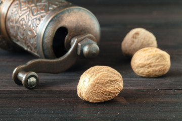 dry nutmeg on dark wooden table