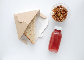 Top view sandwich, dessert and fruit drink on the table