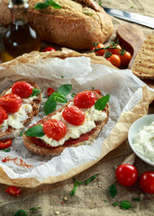 Tomato Ricotta Bruschetta with sun dried tomatoes paste, olive oil brown bread and basil