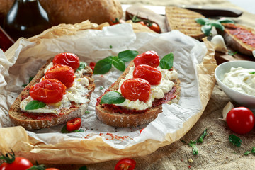 Tomato Ricotta Bruschetta with sun dried tomatoes paste, olive oil brown bread and basil