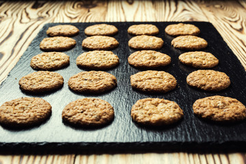 Biscuit sweet cookie background. Domestic stacked butter biscuit pattern concept,close up macro.Homemade cookies on wooden table.Cereal biscuits with the sesame,peanuts,sunflower and amaranth.