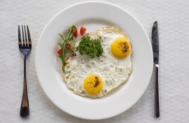 frying eggs with tomatoes