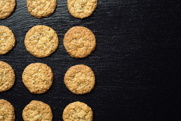 Biscuit sweet cookie background. Domestic stacked butter biscuit pattern concept,close up macro.Homemade cookies on wooden table.Cereal biscuits with the sesame,peanuts,sunflower and amaranth.