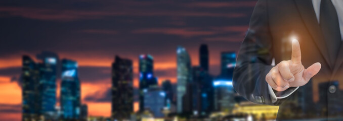 Close up of businessman touching digital screen with finger. Business concept.Financial charts showing growing revenue on touch screen