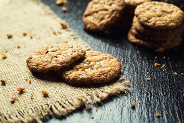 Biscuit sweet cookie background. Domestic stacked butter biscuit pattern concept,close up macro.Homemade cookies on wooden table.Cereal biscuits with the sesame,peanuts,sunflower and amaranth.