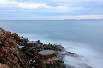 Long exposure image of a rocky beach in Anilao