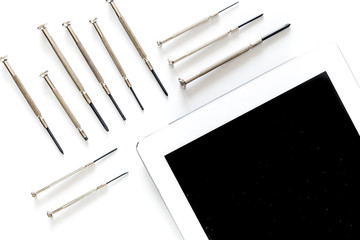 Daignostic of gadgets. Tablet computer and screwdrivers on white background top view mockup