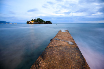 Perspective view of a stone pier in a completely calm sea in Anilao, Batangas