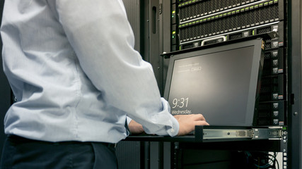 Close up part of administrator working in data center